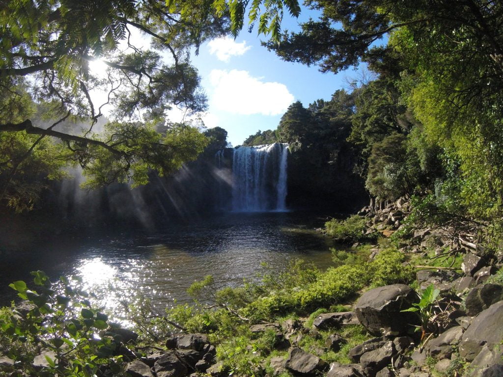 view of a waterfall through some trees