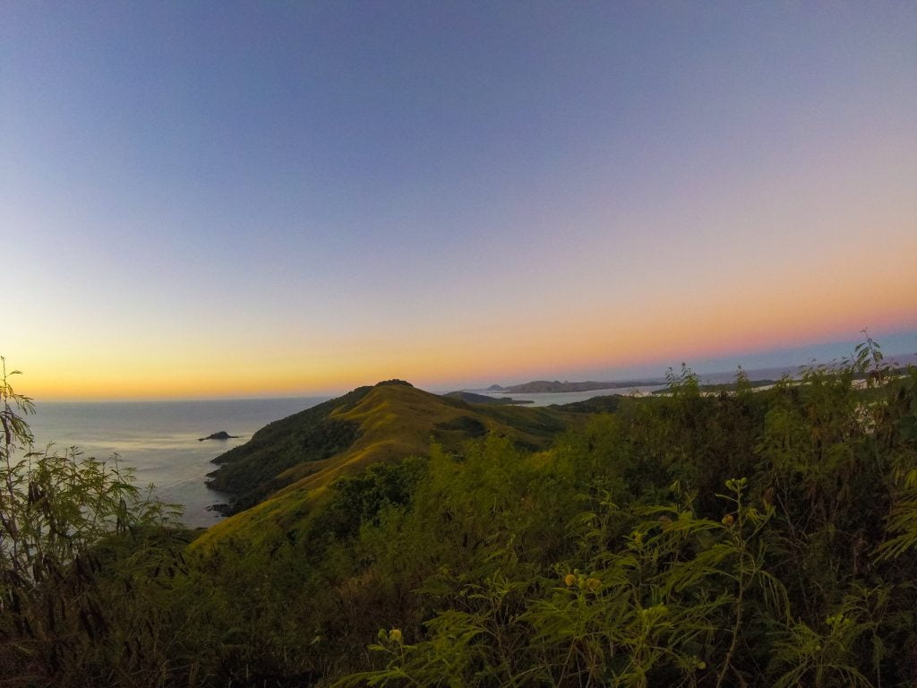Sunrise over a rugged landscape and ocean