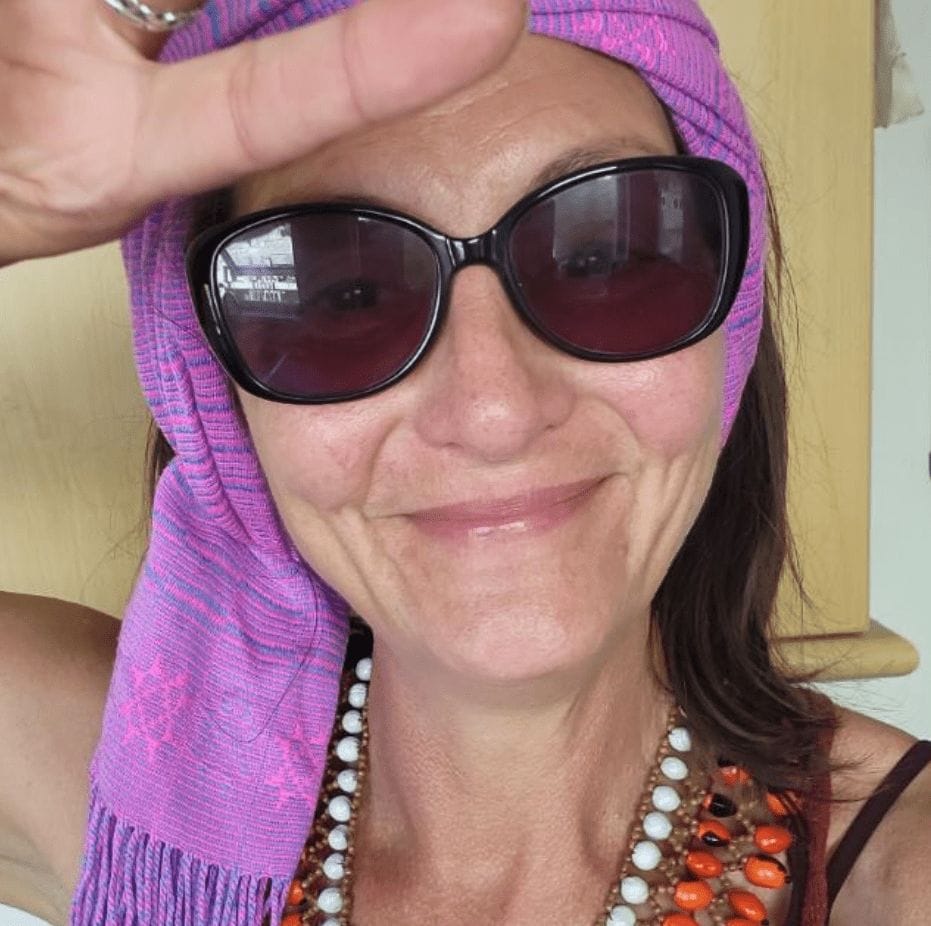 Vanessa Matthews smiling in a headscarf and sunglasses, conveying warmth, authenticity, and a joyful approach to mindfulness.